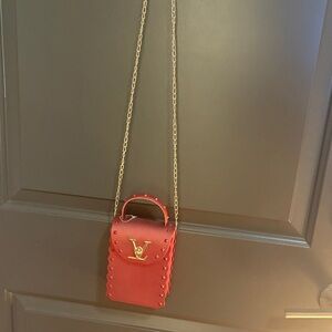 Red Crossbody Bag. Don’t think it’s genuine louis vuitton